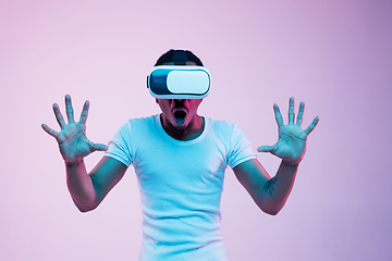 Image showing Young african-american man\'s using VR-glasses in neon light