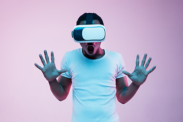 Image showing Young african-american man\'s using VR-glasses in neon light