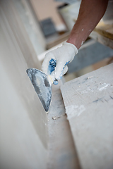 Image showing construction worker plastering on gypsum walls