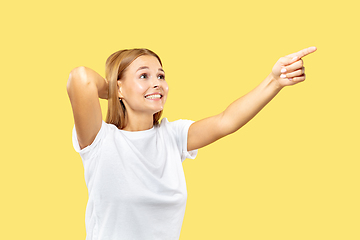 Image showing Caucasian young woman\'s half-length portrait on yellow background