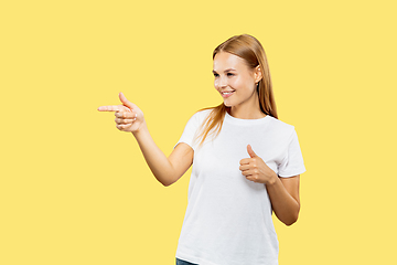 Image showing Caucasian young woman\'s half-length portrait on yellow background