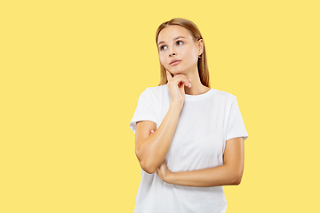 Image showing Caucasian young woman\'s half-length portrait on yellow background