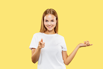 Image showing Caucasian young woman\'s half-length portrait on yellow background