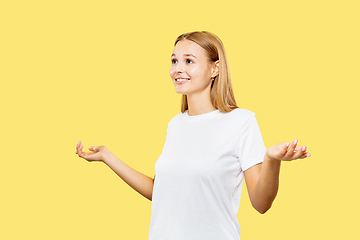 Image showing Caucasian young woman\'s half-length portrait on yellow background