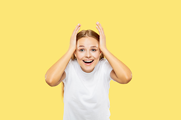 Image showing Caucasian young woman\'s half-length portrait on yellow background