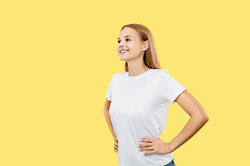 Image showing Caucasian young woman\'s half-length portrait on yellow background