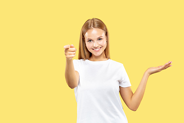 Image showing Caucasian young woman\'s half-length portrait on yellow background