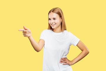 Image showing Caucasian young woman\'s half-length portrait on yellow background