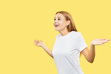 Image showing Caucasian young woman\'s half-length portrait on yellow background