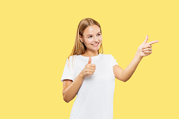 Image showing Caucasian young woman\'s half-length portrait on yellow background