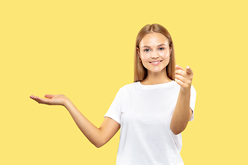 Image showing Caucasian young woman\'s half-length portrait on yellow background