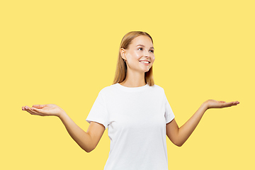 Image showing Caucasian young woman\'s half-length portrait on yellow background