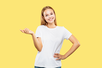 Image showing Caucasian young woman\'s half-length portrait on yellow background