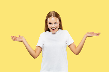 Image showing Caucasian young woman\'s half-length portrait on yellow background