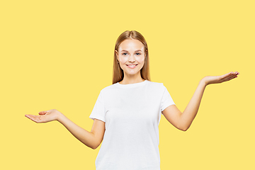 Image showing Caucasian young woman\'s half-length portrait on yellow background