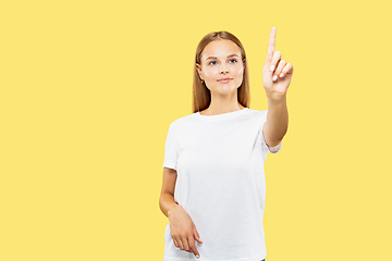 Image showing Caucasian young woman\'s half-length portrait on yellow background