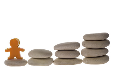 Image showing Figurine on stack of pebbles
