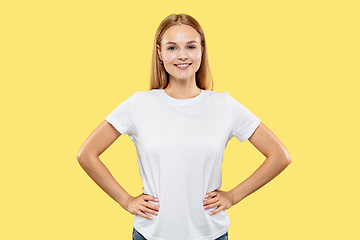 Image showing Caucasian young woman\'s half-length portrait on yellow background