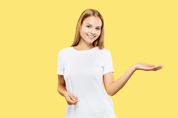 Image showing Caucasian young woman\'s half-length portrait on yellow background