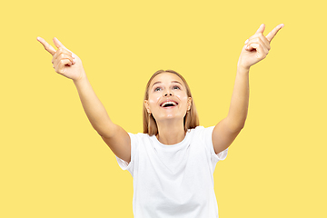 Image showing Caucasian young woman\'s half-length portrait on yellow background