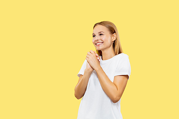 Image showing Caucasian young woman\'s half-length portrait on yellow background