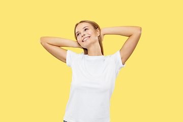 Image showing Caucasian young woman\'s half-length portrait on yellow background