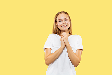 Image showing Caucasian young woman\'s half-length portrait on yellow background