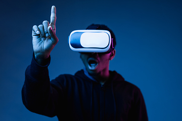 Image showing Young african-american man\'s using VR-glasses in neon light