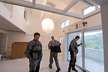 Image showing carpenters installing a balcony door