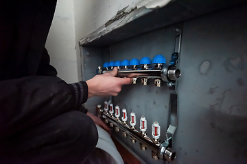 Image showing engineer checking technical data of heating system