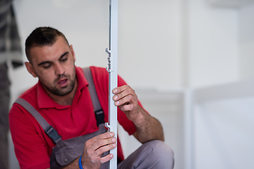 Image showing worker installing a new kitchen