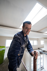 Image showing construction worker plastering on gypsum ceiling