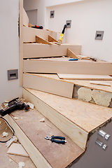 Image showing work in progress on stylish interior with wooden stairs