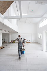 Image showing workers installing the ceramic wood effect tiles on the floor