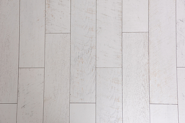 Image showing Ceramic wood effect tiles and tools for tiler on the floor