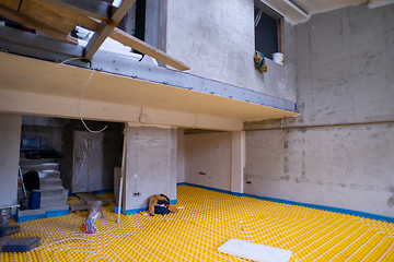 Image showing yellow underfloor heating installation with white pipes