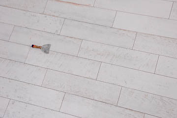 Image showing Ceramic wood effect tiles and tools for tiler on the floor