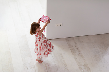 Image showing little girl enjoying while playing with mother\'s jewelry