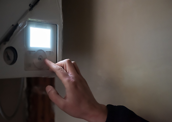 Image showing engineer checking technical data of heating system