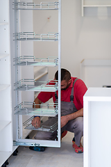 Image showing worker installing a new kitchen