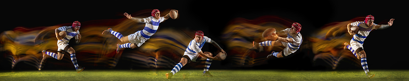 Image showing One caucasian man playing rugby on the stadium in mixed light