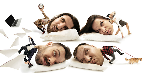 Image showing Big heads on small bodies lying on the pillow