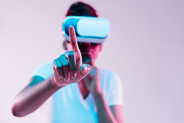 Image showing Young african-american woman\'s using VR-glasses in neon light