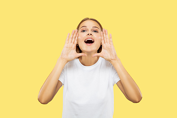 Image showing Caucasian young woman\'s half-length portrait on yellow background