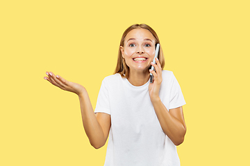 Image showing Caucasian young woman\'s half-length portrait on yellow background