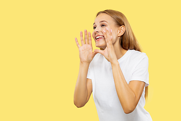 Image showing Caucasian young woman\'s half-length portrait on yellow background