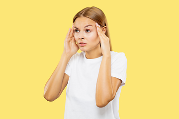 Image showing Caucasian young woman\'s half-length portrait on yellow background