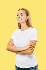 Image showing Caucasian young woman\'s half-length portrait on yellow background