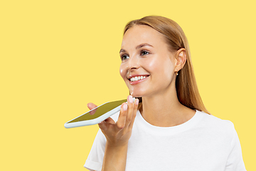 Image showing Caucasian young woman\'s half-length portrait on yellow background