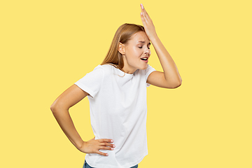 Image showing Caucasian young woman\'s half-length portrait on yellow background